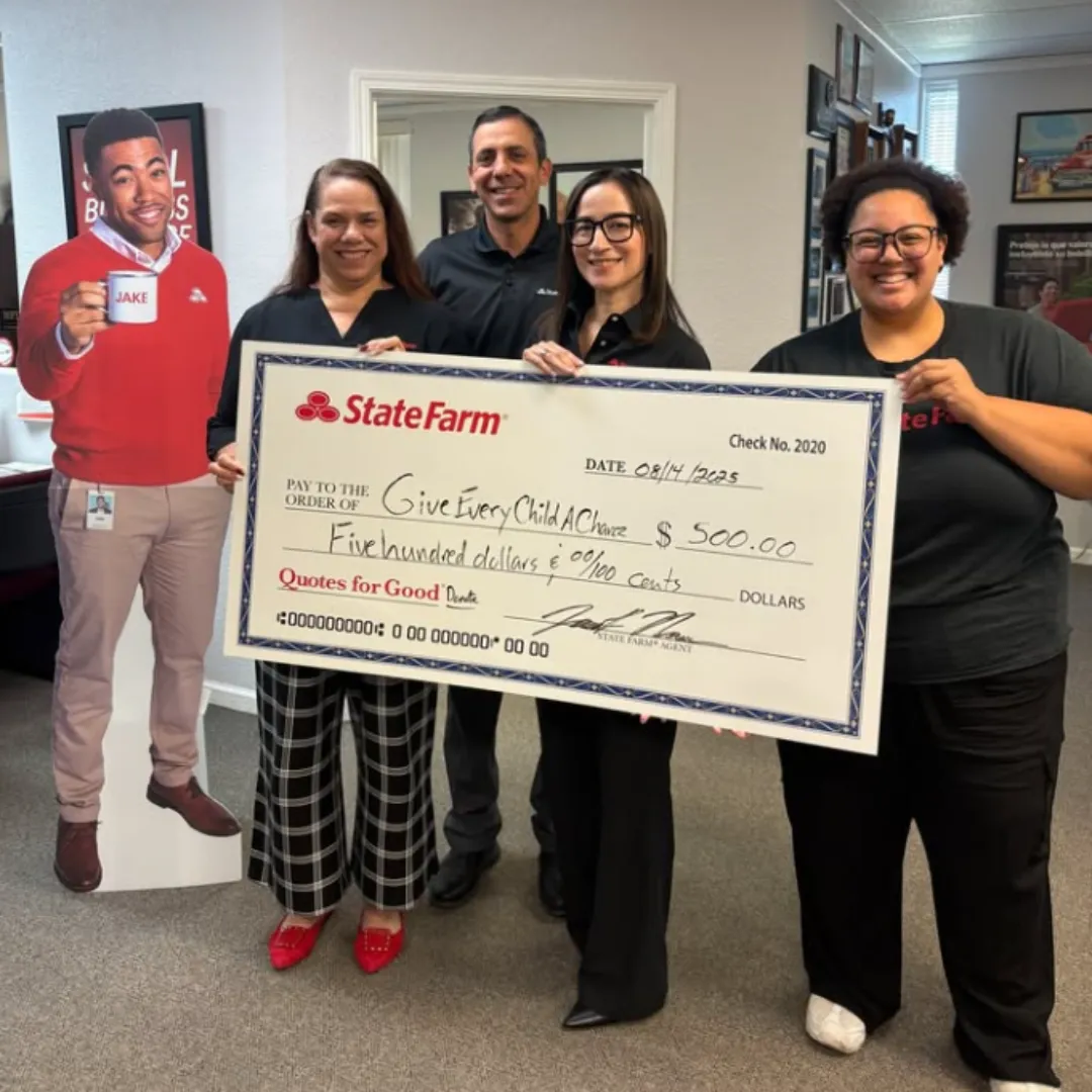 Local business sponsors presenting a large donation check to GECAC